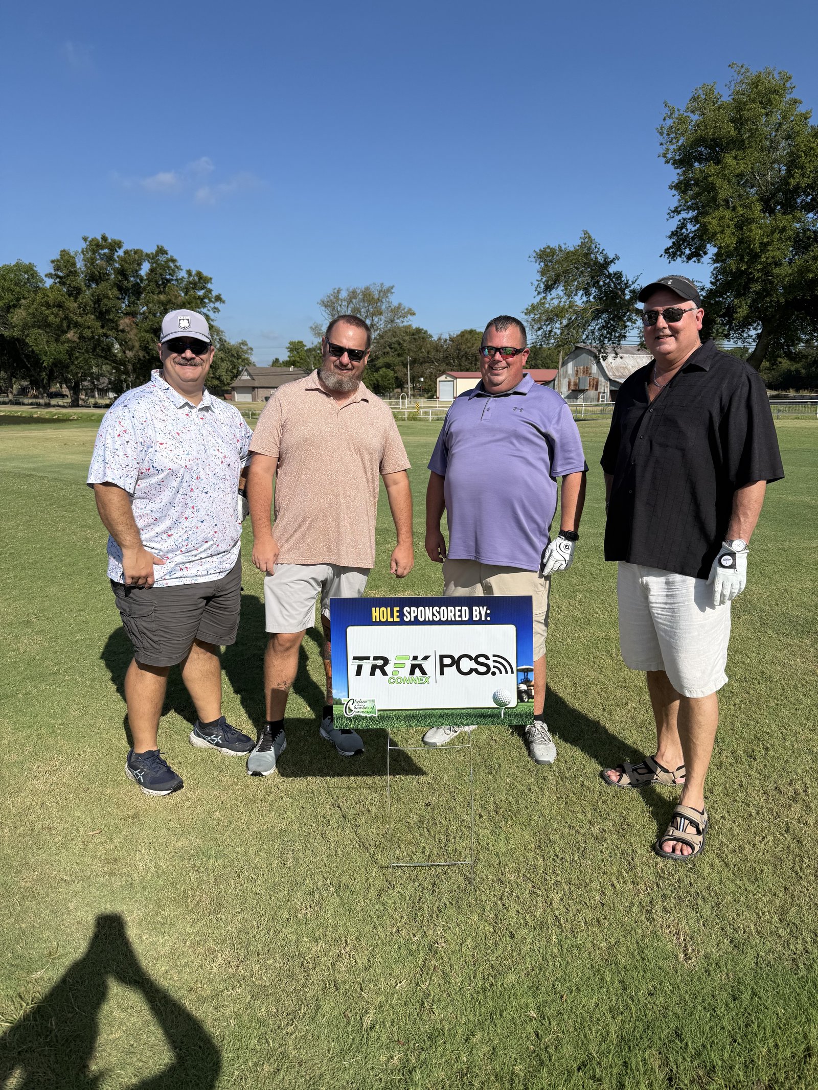 TREK Connex team at the Chris Bennett Memorial Golf Tournament hole sponsorship sign